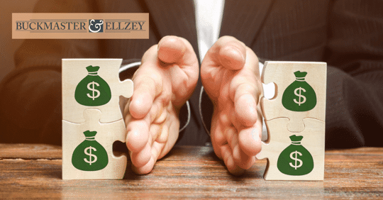 Lawyer dividing puzzle pieces with money bags on them