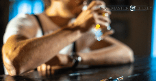 man drinking a beer at a bar